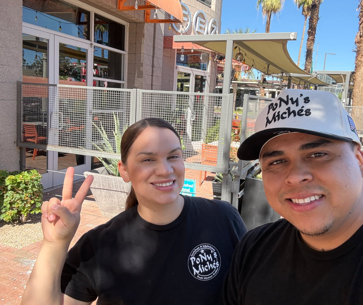 PoNy's Miches owners in front of downtown building.
