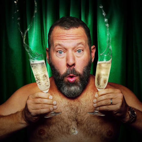 Comedian poses with champagne glasses