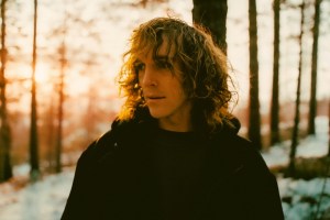 Artist Felly poses in forest