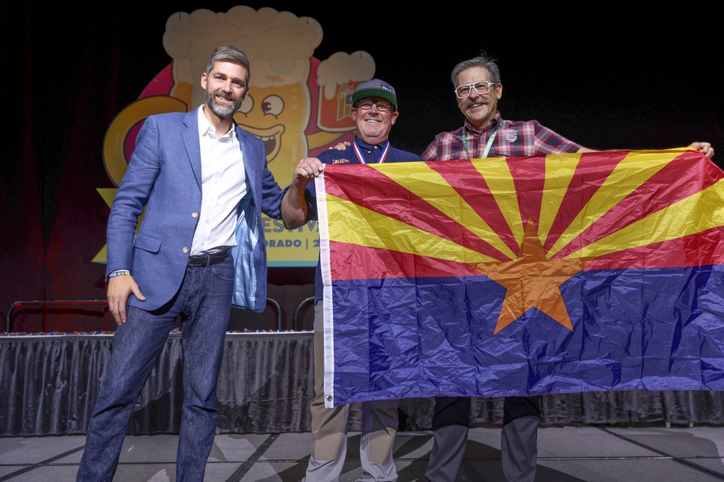 Three men on stage at the Great American Beer Festival awards.