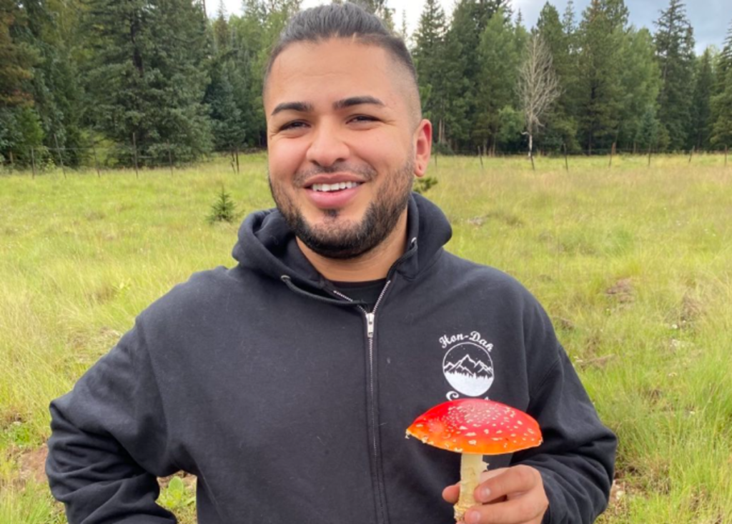a man holds a mushroom