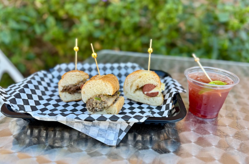 Sandwiches on a tray with a drink.