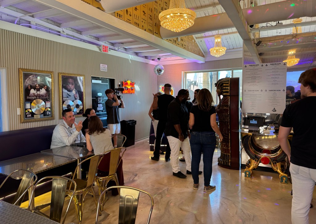 Busy restaurant with several customers standing