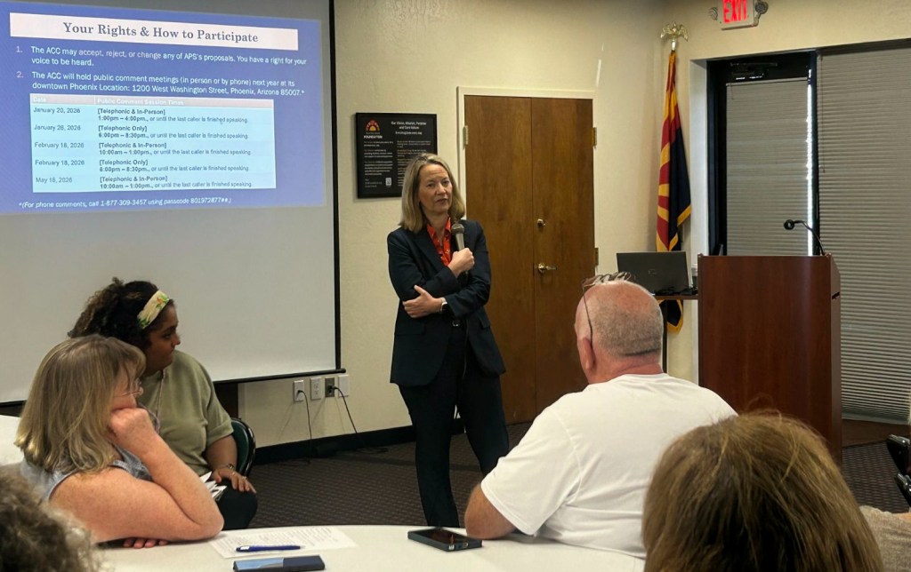 kris mayes speaks to a room of people