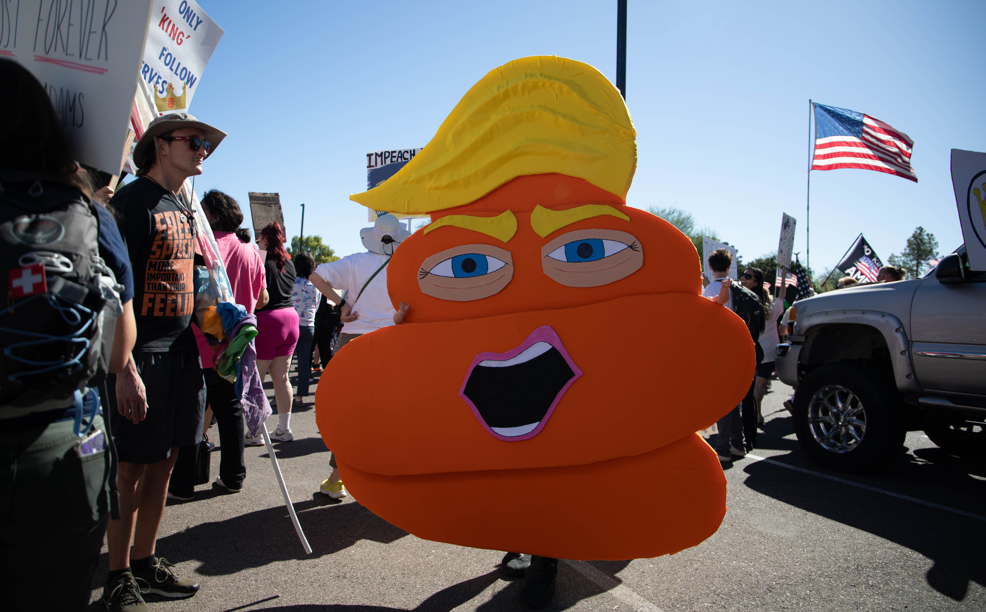 donald trump as an orange pile of poop with baby doll arms