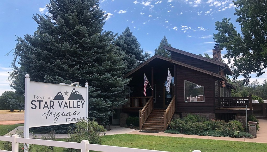 a small cabin that says "Star Valley Town Hall"