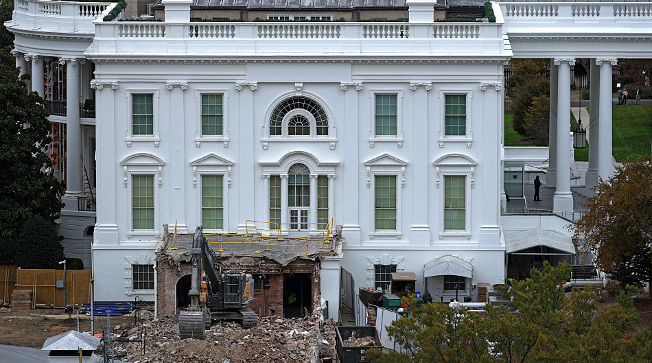 construction machinery tearing down a wing of the white house