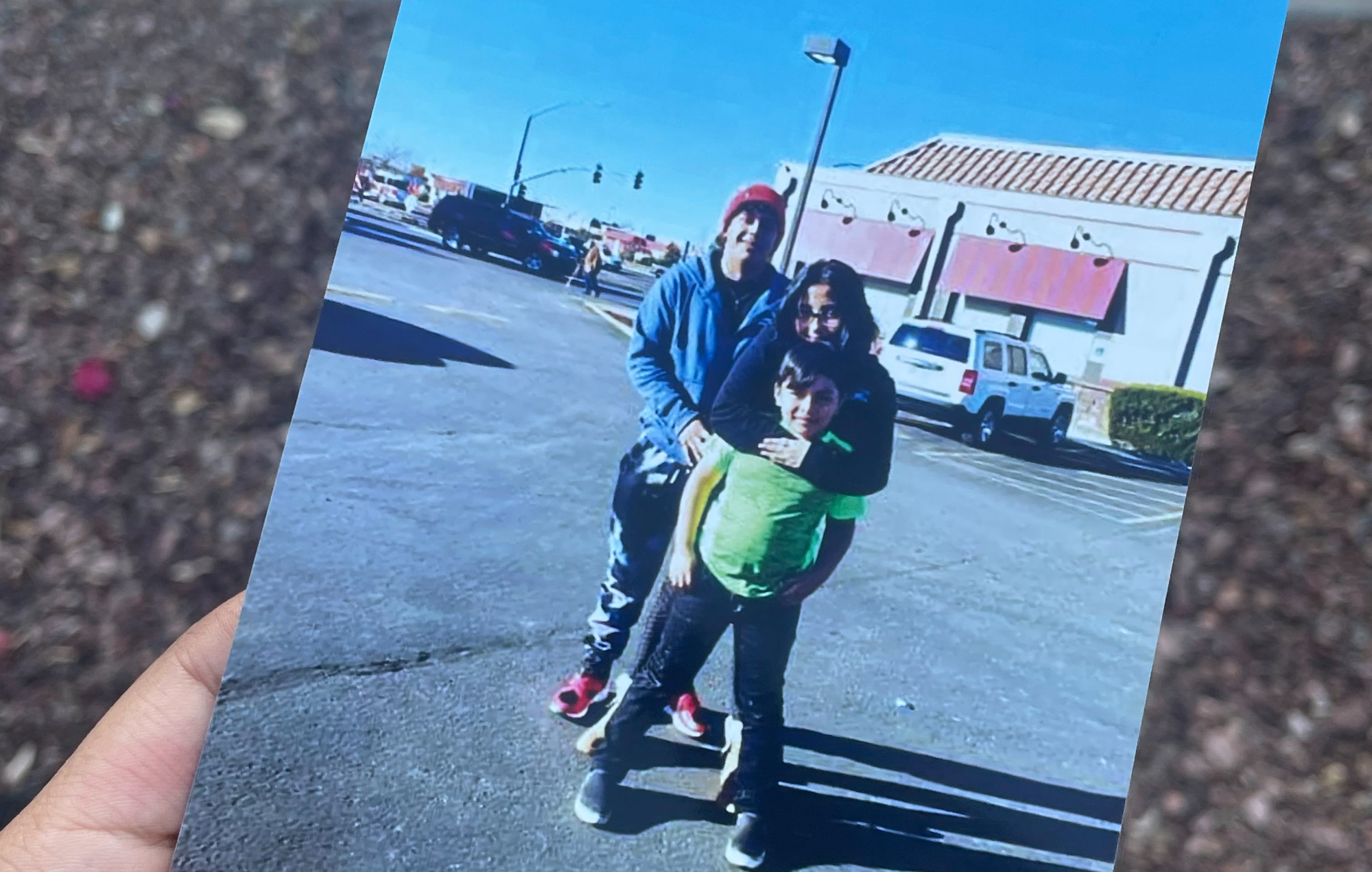 two young adults and a adolescent boy in a family photo