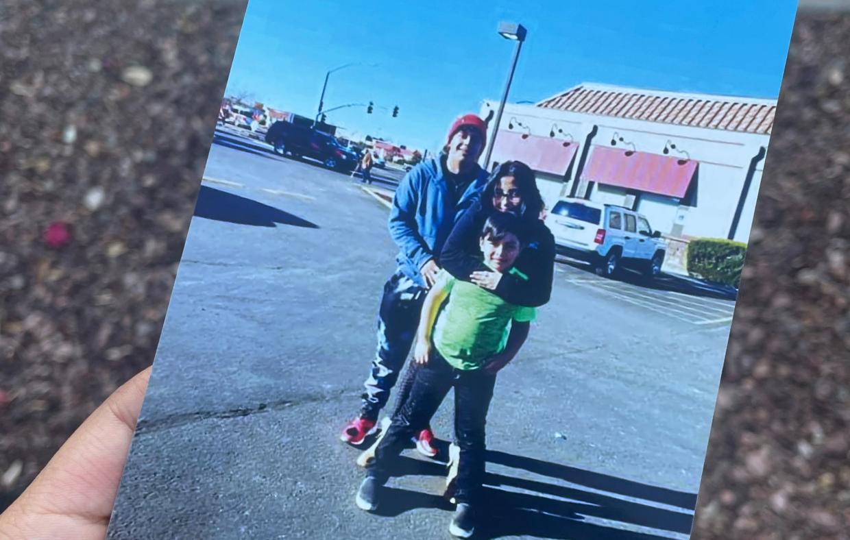 two young adults and a adolescent boy in a family photo