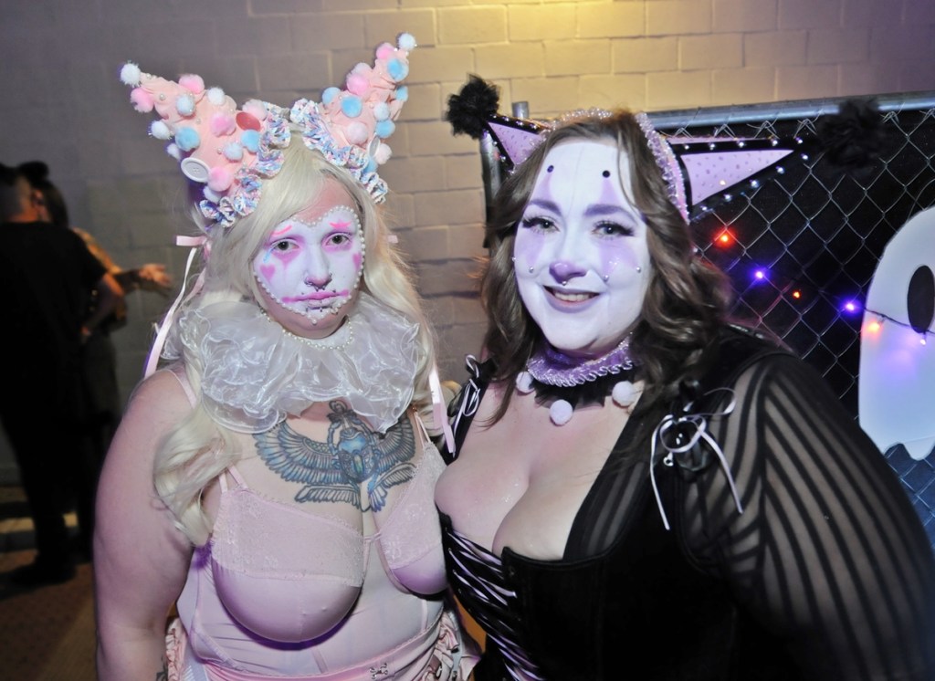 Two women dressed as fanciful clowns.