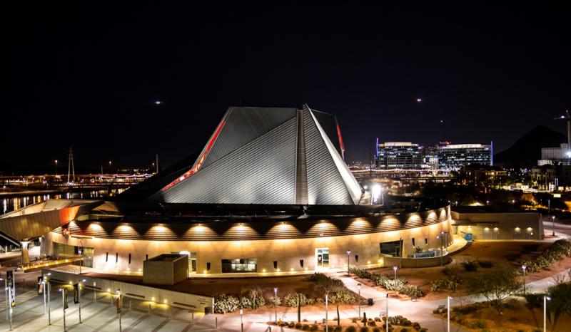 An aerial view of an enormous angular surrounded by lights.