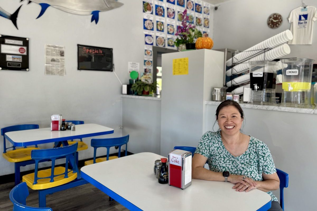 Blue Fin owner Lyn Yee sits inside her restaurant.