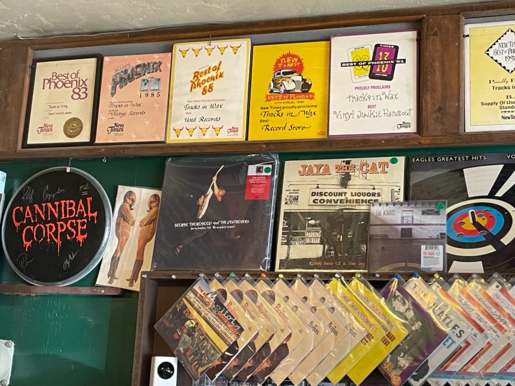 records and plaques on a record shop wall