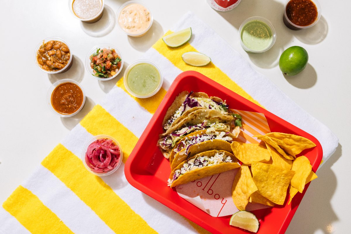 A platter of tacos and salsas.