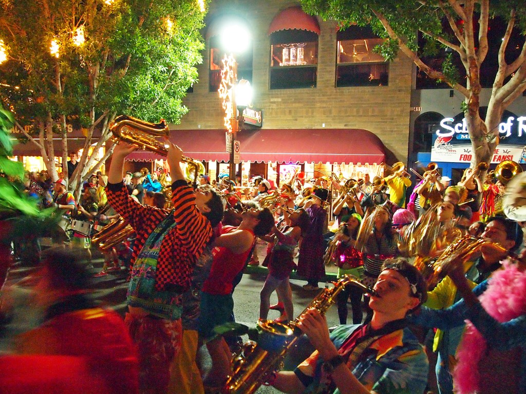 A band performs on a crowded street,