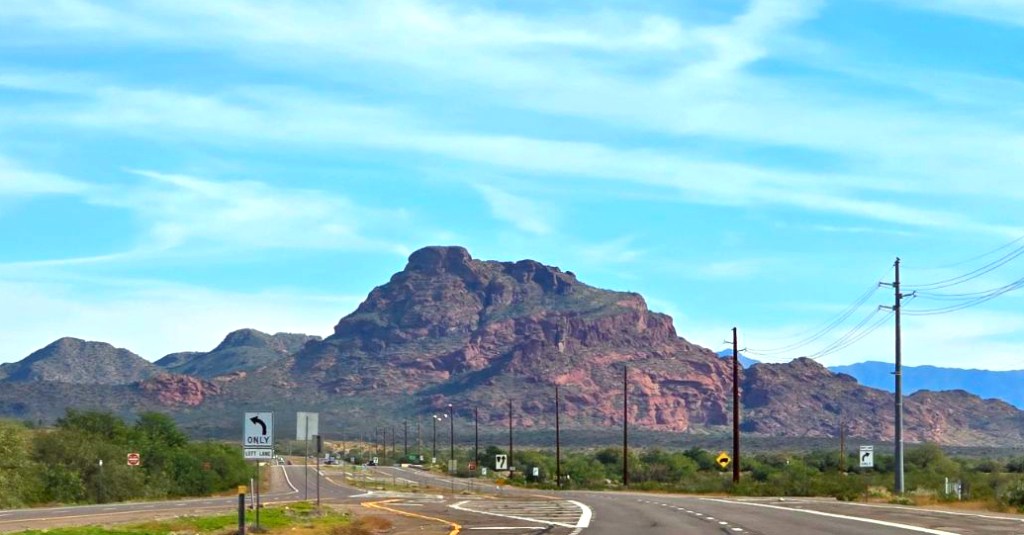 a mountain in arizona with green undergrowth