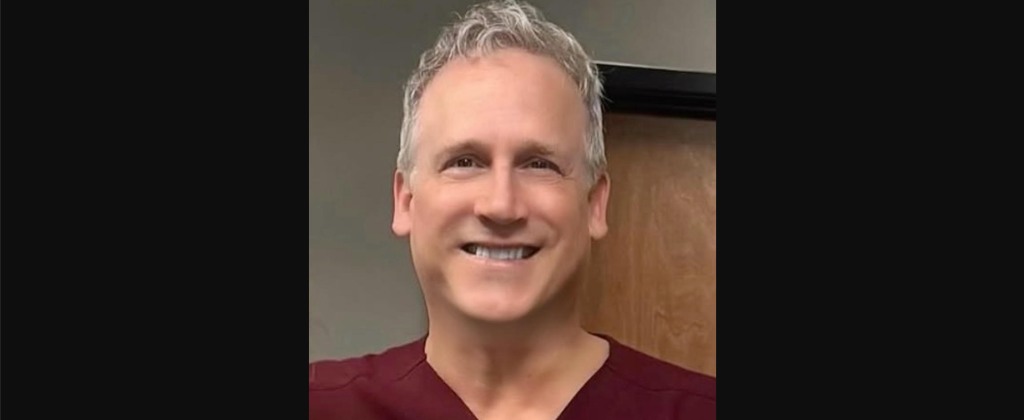a man in maroon scrubs