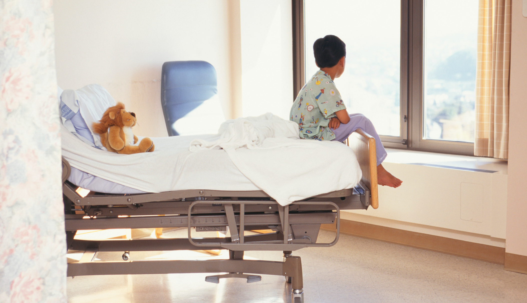 a child sits on a hospital bed