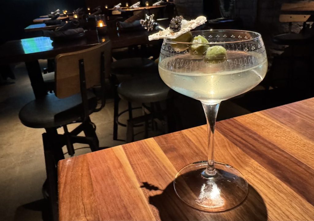 A dirty martini on a table.