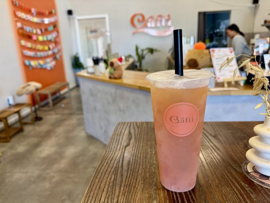 An iced tea on a table in a boba shop.
