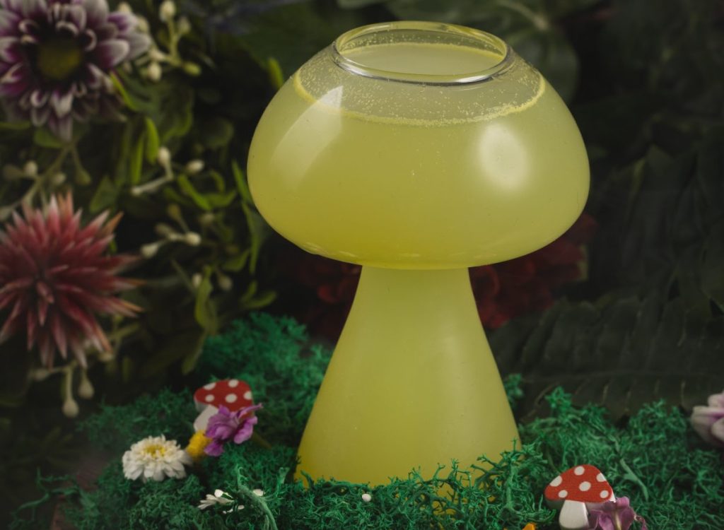 A cocktail in a mushroom-shaped glass.