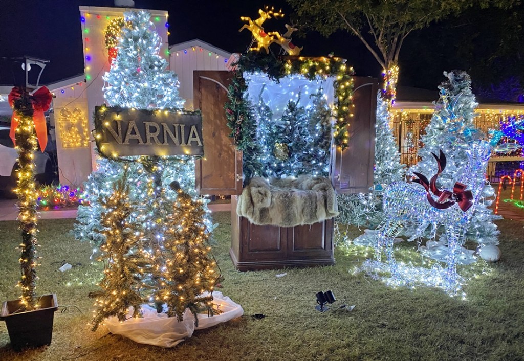 Holiday decorations and lights in the front yard of a home.
