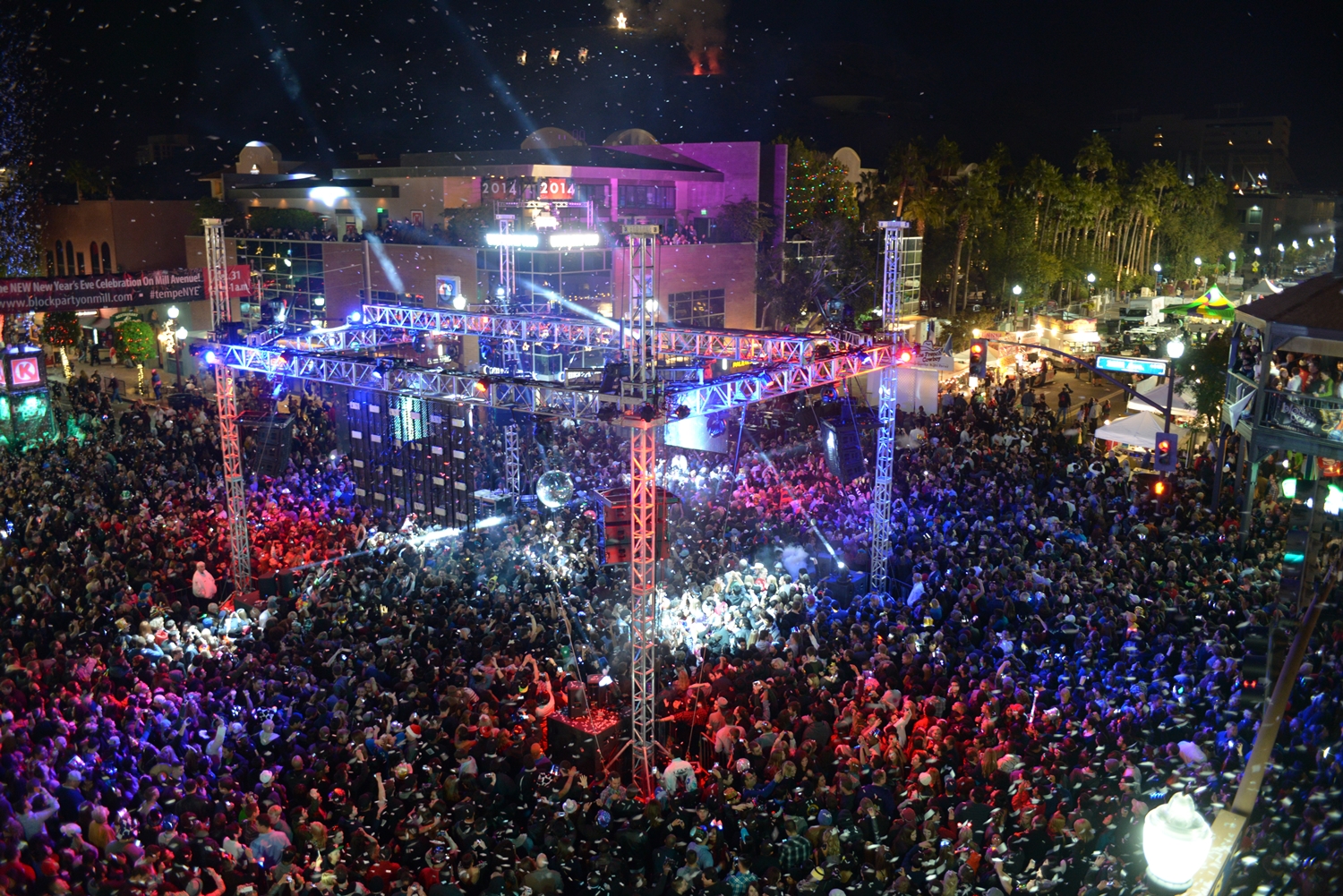 A block party packed with people at night.
