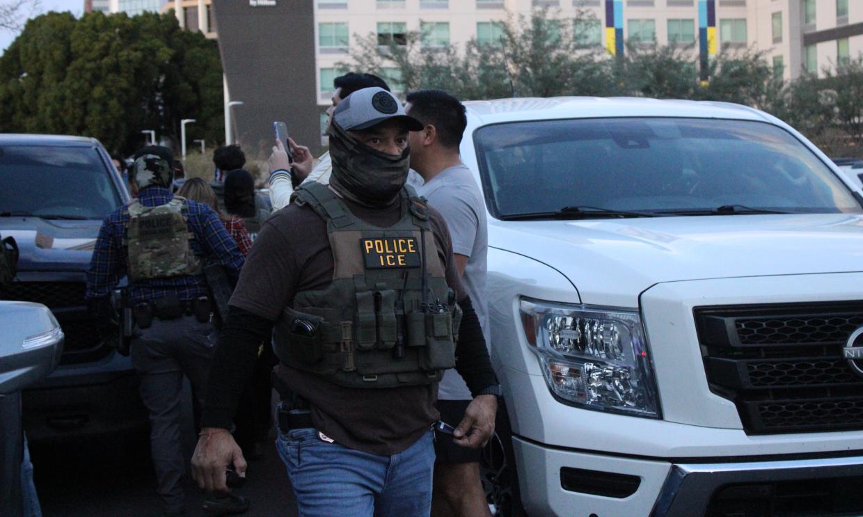 a masked ice agent
