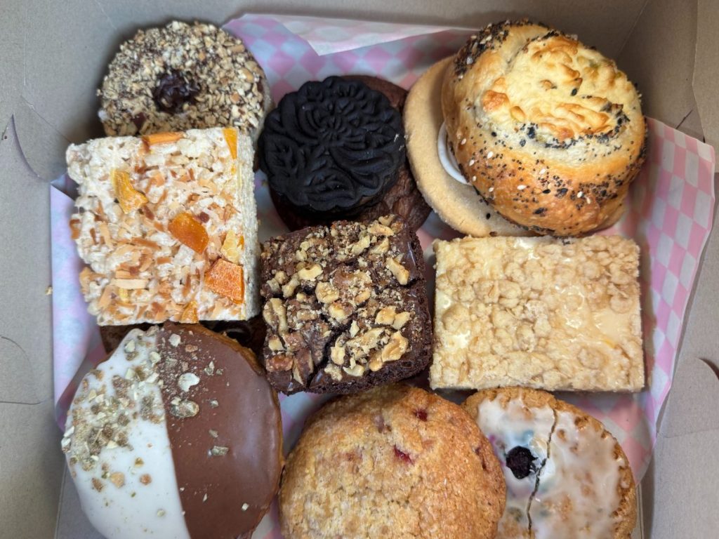 A pastry box filled with baked goods.