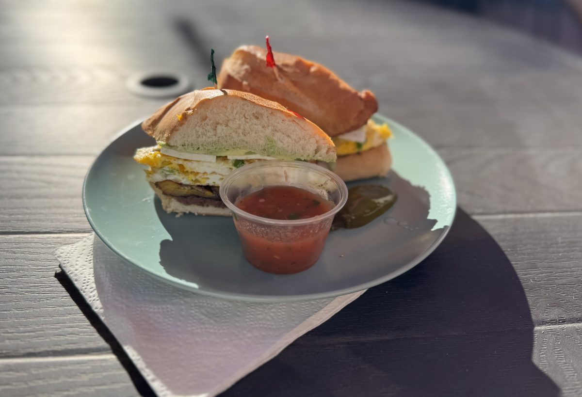 A large breakfast sandwich on a plate.