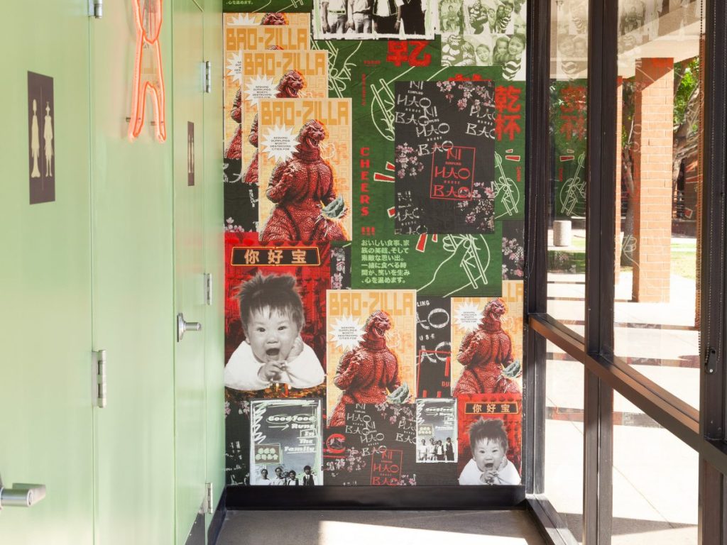 A wall decorated with vintage "Godzilla"-inspired posters.