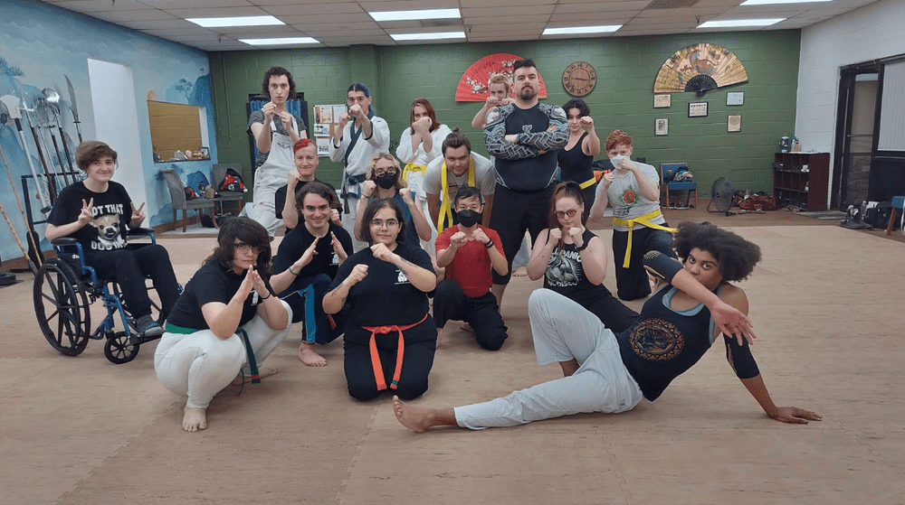 people pose in a martial arts studio