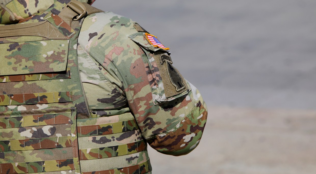 A stock photo of a soldier in fatigues.