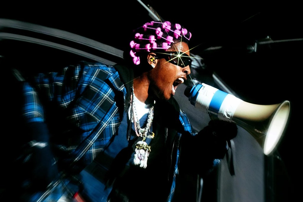 A$AP Rocky performs onstage with a megaphone during a concert.