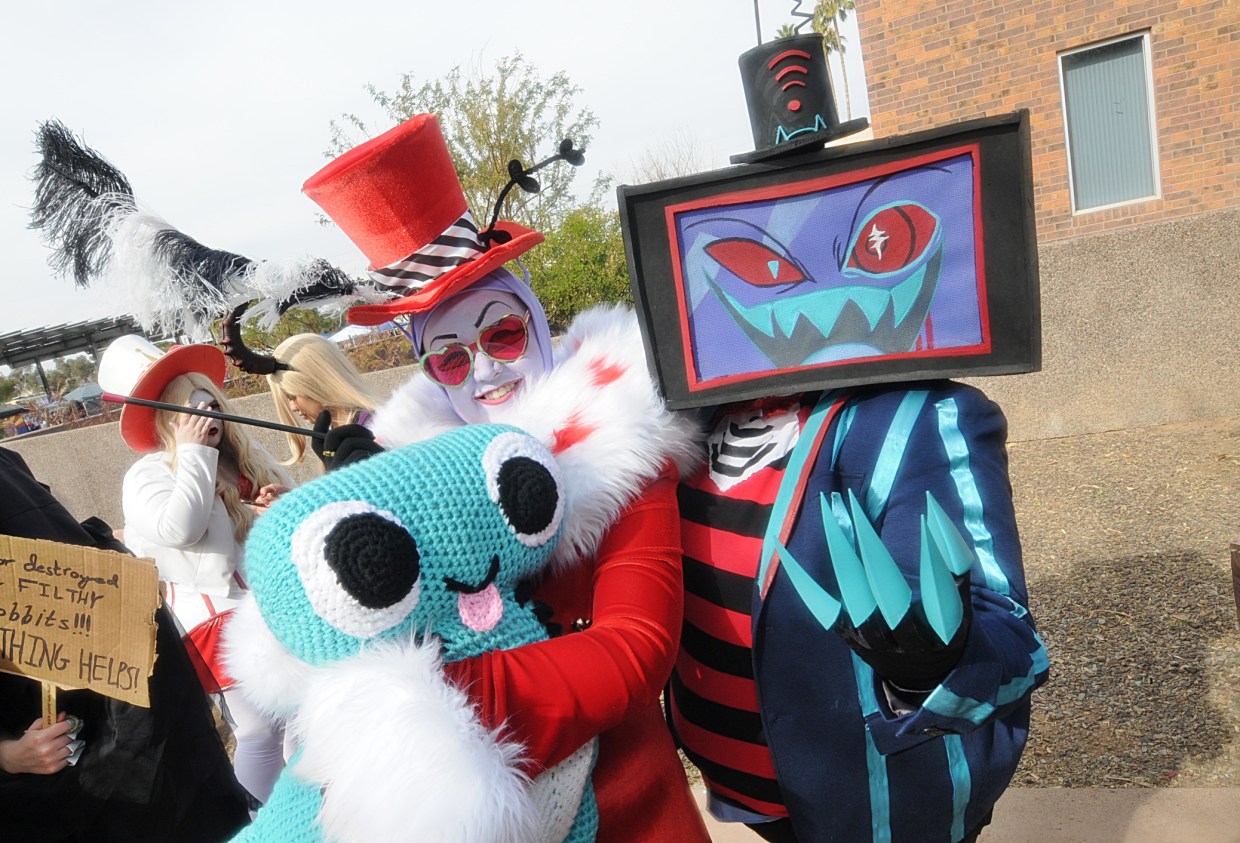 Two cosplayers dressed as characters from "Hazbin Hotel."