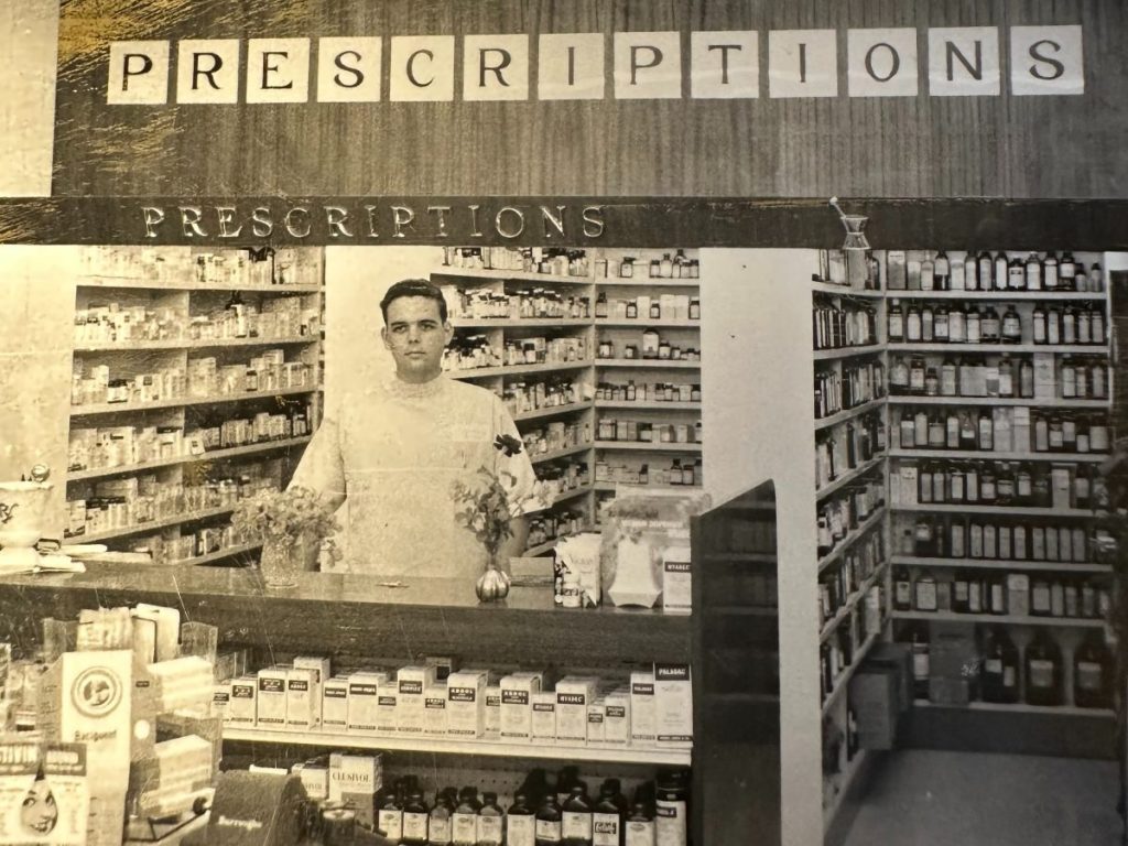 A man behind a pharmacy counter