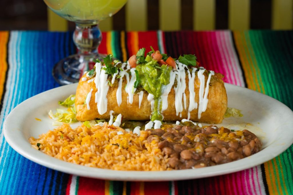 A chimichanga platter with a margarita.