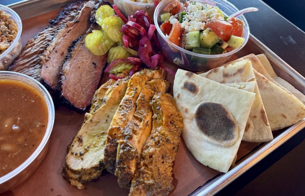 A barbecue platter with sliced brisket and turkey.