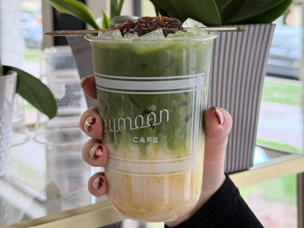 An iced matcha latte topped with a date.