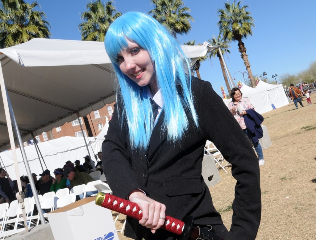 A female cosplayer dressed as Kasumi Miwa from the anime series "Jujutsu Kaisen."
