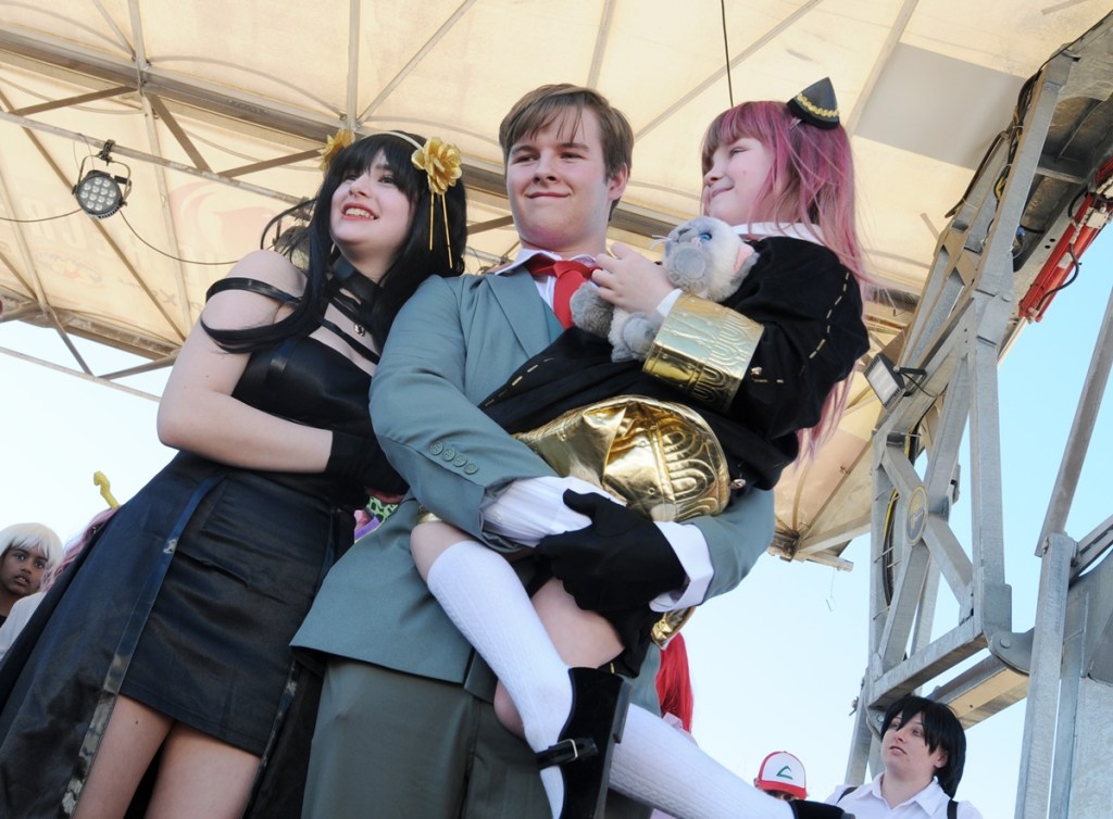 Three cosplayers portray the the Forger family from the Japanese web manga series “Spy x Family" at Arizona Matsuri 2026 in Phoenix.