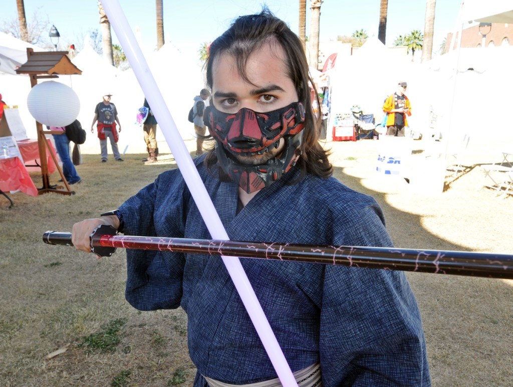 A male cosplayer dressed in a cosplay mashup of Darth Maul and a traditional Japanese warrior.