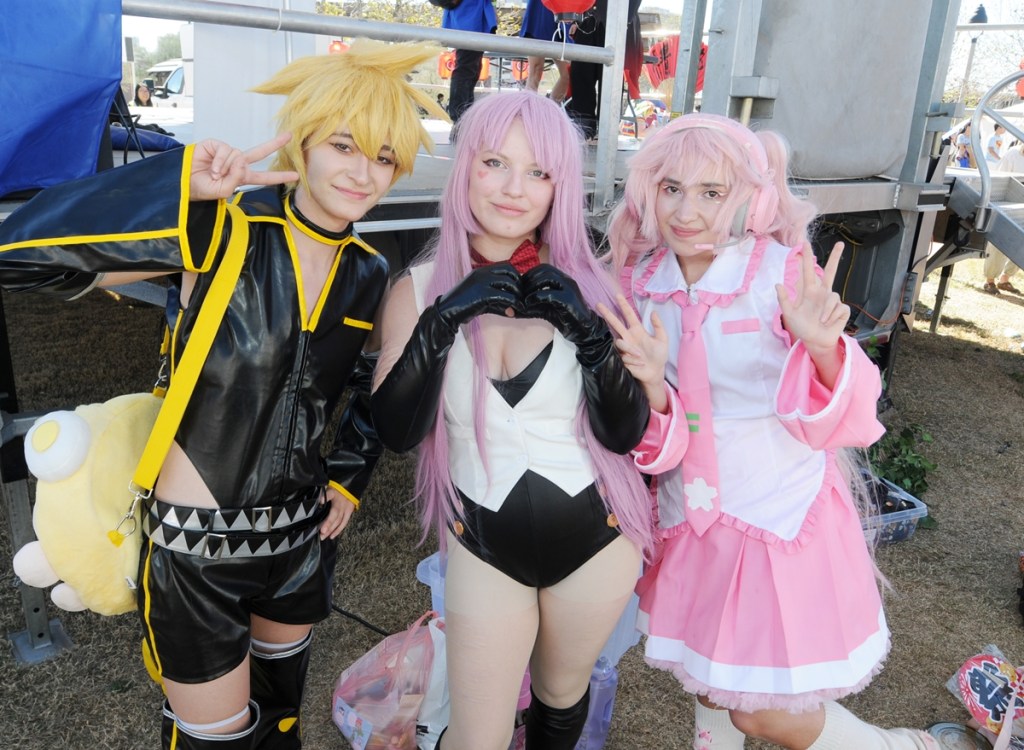 Cosplayers portraying Japanese Vocaloids Kagamine Len, left, Megurine Luka, center, and Hatsune Miku at Arizona Matsuri 2026.