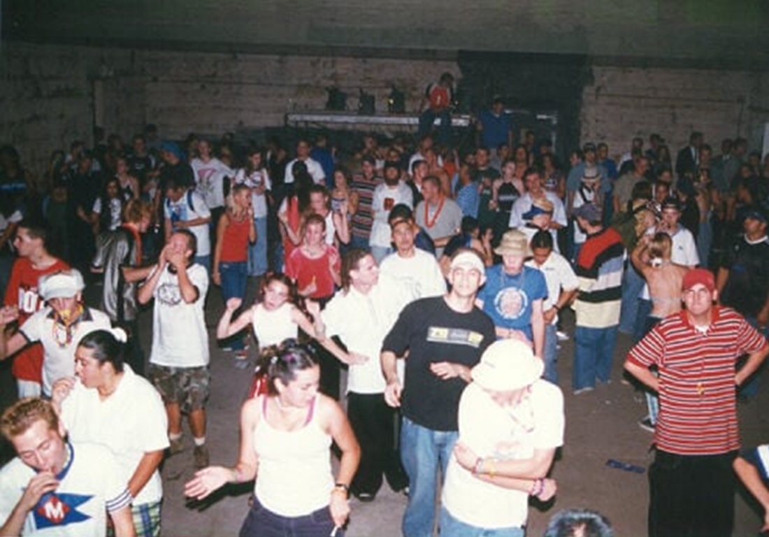 A crowd of ravers at an indoor venue.