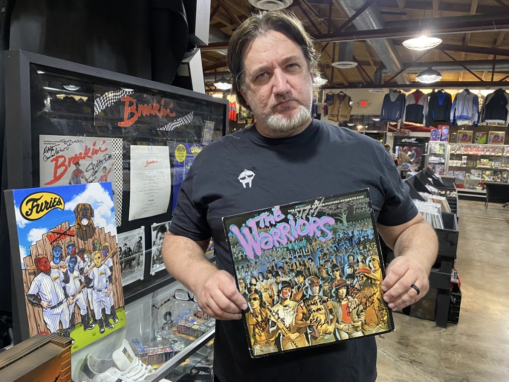 Chuck Huus, owner of Trill Hip Hop Shop in Phoenix, holding an autographed copy of "The Warriors" soundtrack LP.