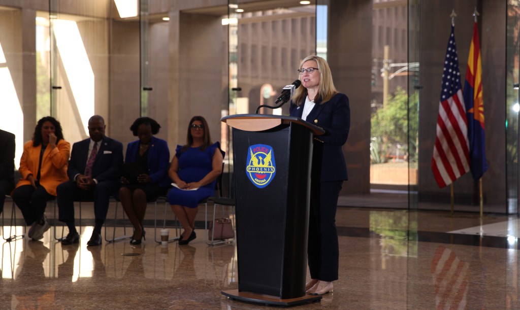 phoenix mayor kate gallego speaks at a phoenix police podium