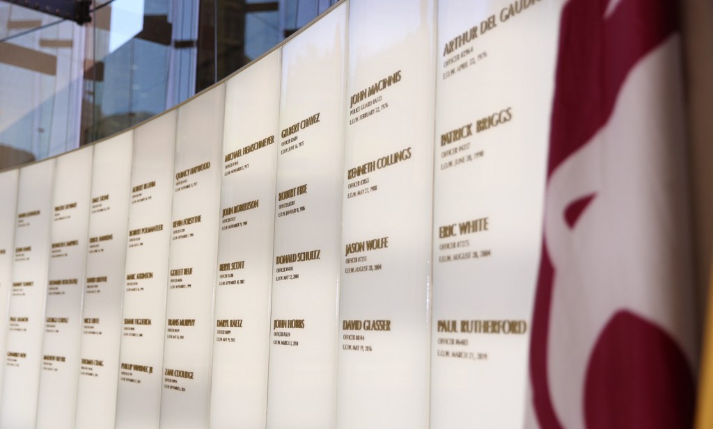 a wall featuring the names of phoenix police officers killed in the line of duty