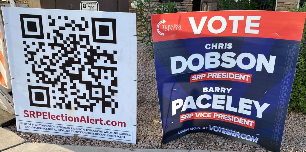 two signs promoting candidates in SRP's election. One is from Turning Point Action. The other features a large QR code and lists Google among its supporters on the bottom.