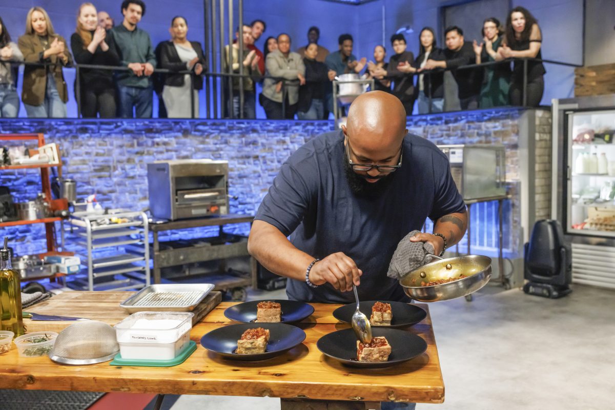Chef Devan Cunningham plates food in the kitchen arena of the Food Netwrok show, "Beat Bobby Flay."