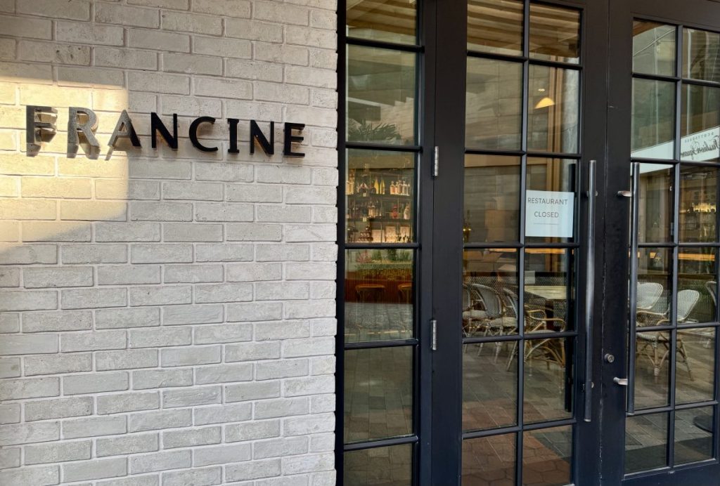 A "restaurant closed" sign hangs in the glass door of Francine.